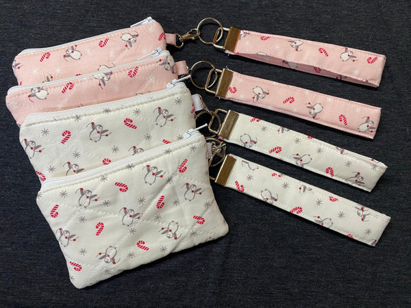 Set of fabric pouches with matching keychains on a dark background