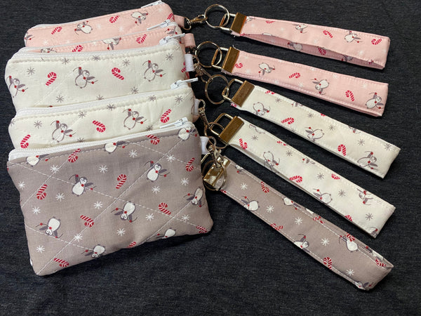 Set of fabric pouches with matching keychains on a dark background